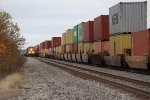 Westbound grain loads approach on Track 1 as eastbound stacks pass on 2